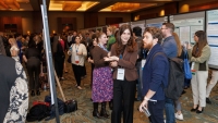Gabriella Restifo-Bernstein's poster being reviewed at a conference in 2024